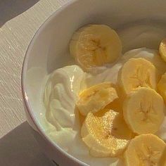 a bowl filled with yogurt and sliced bananas