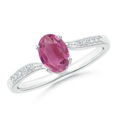 The oval pink tourmaline exudes a pleasing pink hue and looks breathtakingly beautiful at the center of the 14k white gold ring. Sparkling diamonds accentuate the shoulders and the charm of the center stone. The lustrous shank of this solitaire pink tourmaline ring slightly curves towards the ends, forming a graceful bypass. Rubellite Ring, Pink Tourmaline Jewelry, Pink Sapphire Jewelry, Pink Tourmaline Ring, London Blue Topaz Ring, Bypass Ring, Tourmaline Jewelry, Pink Ring, American Diamond