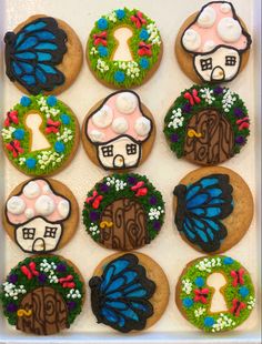 decorated cookies in the shape of fairy doors and mushrooms are displayed on a white tray