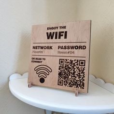 a wooden sign that says, enjoy the wifi network password with qr code on it