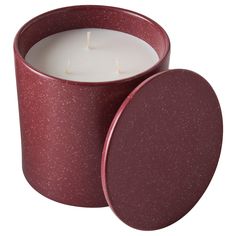 a candle in a red tin on a white background