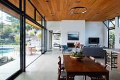 a dining room and living room with wood ceiling