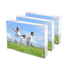 three clear acrylic photo frames with family running in the grass