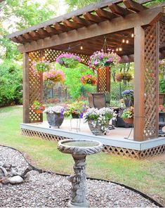 a gazebo with potted plants and lights on it