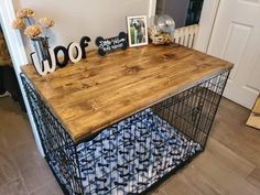 a wooden table with metal cage on top