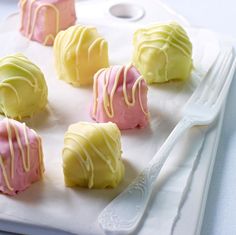 there are many desserts on the tray ready to be cut into bite size pieces