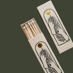 two matchesticks with designs on them sitting next to each other