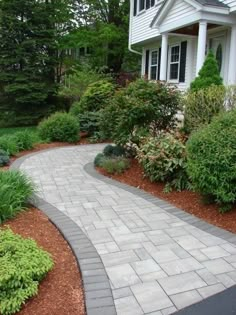 a walkway in front of a white house