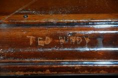 an old wooden box with writing on it