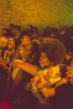 two women hugging each other in front of an audience