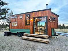 the tiny house is built on wheels and has windows that look like they are made out of wood