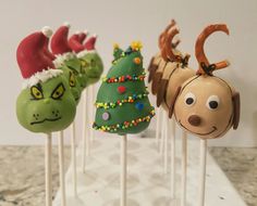 the cake pops are decorated like christmas trees and reindeer heads with antlers on them