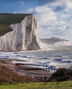 white cliffs on the coast with waves crashing against them