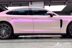 a pink car parked in front of a building