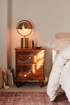 an image of a bedroom with a bed and nightstand