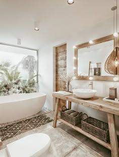 a bathroom with a sink, mirror and bathtub in front of a large window