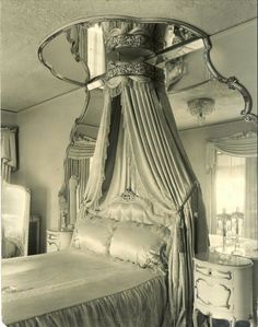 an antique photo of a canopy bed in a bedroom