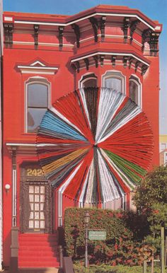 a large red building with an umbrella in front of it