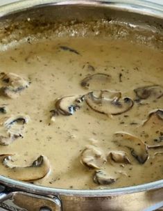 a pan filled with mushrooms sitting on top of a stove