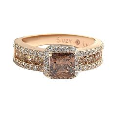 an engagement ring with a brown diamond in the center and two white diamonds around it