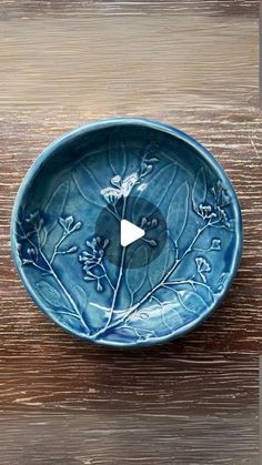 a blue bowl sitting on top of a wooden table