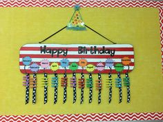 a happy birthday sign hanging on a wall with clothes pins in the shape of animals