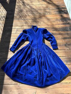 Fab vintage cobalt blue velvet dress from Norma Kamali, marked Petite and runs quite tiny - our model wears a modern S-M and couldn't get into it so please check dimensions given carefully.  Dress is gorgeous with a snap closure all the way up the high neck, shoulder pads, 2 (TWO pockets, and dropped V waist on front and back.  4" of hem let you easily adjust it longer if needed.  Excellent vintage condition with no marks or holes, this is a substantial, weighty dress that will make you feel lik Blue Fitted Long Sleeve Velvet Dress, Fitted Blue Vintage Dress For Costume Party, Blue Dresses For Fall Costume Party, Blue Fall Costume Party Dress, Blue Vintage Winter Dresses, Vintage Fashion 1980s, Fashion 1980s, Vintage Dress 80s, Blue Velvet Dress