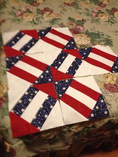 an american flag quilt on top of a bed