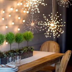 the table is set with place settings for two people to sit at, and fireworks are in the background