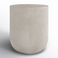 a concrete vase sitting on top of a white surface