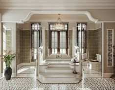 an elegant bathroom with tiled floors and walls