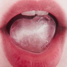 an open mouth with a heart shaped object in the middle of it's lip