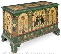 an ornately decorated chest with birds and flowers painted on the sides, in green