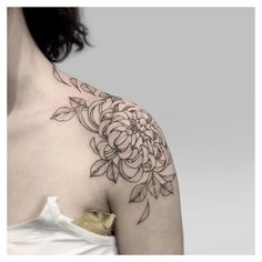 a woman with a flower tattoo on her shoulder