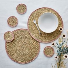 placemats, plates and flowers on a table