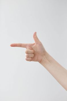 a person's hand is pointing to the left with their index finger in front of them