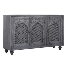 an ornate carved sideboard with three doors