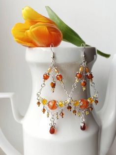 Orange Agate Chandelier Earrings, Dangle Earrings, Charms and Chains, Pendant Earrings, Statement Jewelry, Boho Orange Agate Earrings, Chandelier Dangle Earrings, Charms and Chains, Pendant Drop Earrings, Unique Jewelry Introducing our exquisite Orange Agate Chandelier Earrings, a stunning addition to any jewelry collection. These dangle earrings are crafted with precision, combining elegance and charm in one unique design. Featuring a mesmerizing orange agate pendant, these earrings draw attent Orange Dangle Chandelier Earrings For Gift, Festive Orange Dangle Jewelry, Orange Drop Earrings With Dangling Beads, Unique Orange Jewelry With Dangling Beads, Unique Orange Earrings With Dangling Beads, Chandelier Earrings Diy, Silver Jewelry Accessories, Earthy Jewelry, Orange Agate