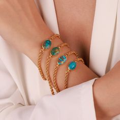 ▶ 𝙋𝙍𝙊𝘿𝙐𝘾𝙏 𝙁𝙀𝘼𝙏𝙐𝙍𝙀𝙎 * 14k Yellow Gold Bracelet * Chain Bracelet Width: 3.50mm * Stone Size : 16mm x 12.00mm OVAL * Chain Color: Yellow Gold ✔️ Made of real turquoise stone. Since turquoise stone is made of natural stone, there may be differences in the colors of the stone. (Because raw stone) ❤️Indulge in the timeless elegance of our Gold Turquoise Oval Bracelet. Handcrafted with love and precision, this exquisite piece features a genuine, natural turquoise stone that is beautifull Elegant Turquoise Bracelets With Cabochon, Oval Link Gemstone Bracelets As Gift, Oval Link Gemstone Bracelet For Gift, Yellow Gold Cabochon Bracelet As Gift, Yellow Gold Oval Bracelets As Gift, Oval Yellow Gold Bracelet For Gift, Blue Oval Bracelet As A Gift, Blue Oval Bracelet As Gift, Turquoise Jubilee Bracelet Jewelry Gift