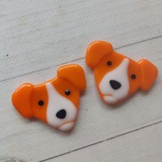 two orange and white teddy bears sitting next to each other