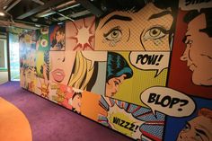 an office with comic themed walls and purple carpet