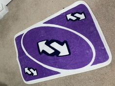 a purple and white rug with arrows on it