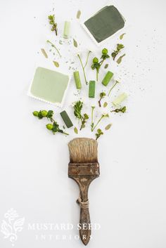 a paintbrush with some flowers on top of it and other things around it that are falling off the wall