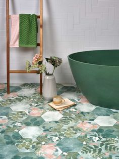 a green bath tub sitting next to a white tiled wall in front of a wooden chair