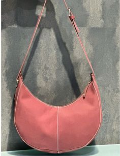 Material :  Leather Dimension:- Measured in Inches Width: 12" Center Height: 6.5" Top Depth: 1.5"  Bottom Depth: 3" Crafted with luxuriously soft genuine buff leather, this stunning half moon shoulder bag adds a touch of feminine elegance to any outfit. The unique curved silhouette offers a modern twist on a classic style, while the spacious interior ensures you can carry all your essentials in style. Featuring a comfortable adjustable shoulder strap for hands-free ease, this versatile bag transitions effortlessly from day to night. Available in a beautiful blush pink hue that complements every look, this bag is sure to become your new favorite accessory. Perfect for everyday use  Half Moon Shoulder Bags, Irregular One-Shoulder Armpit Bag, Minimalist Handbags, Women's Leather Purse, Fashio Moon Shoulder Bag, Minimalist Handbag, Feminine Elegance, Trendy Shoulder Bag, Minimal Fashion, Half Moon, Casual Bags, Leather Purses, Purses And Handbags