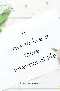 someone is writing on a piece of paper that says 11 ways to live a more international life