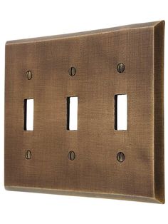 an old fashioned metal switch plate with four holes