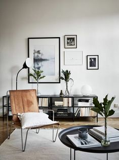 a living room filled with lots of furniture and pictures on the wall above it's coffee table