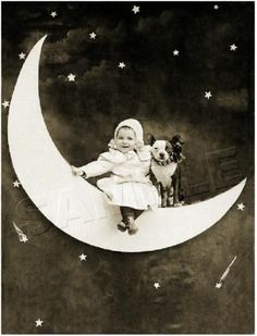 a baby sitting on the moon with a dog