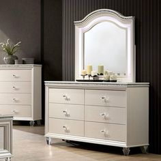 a white dresser and mirror in a room